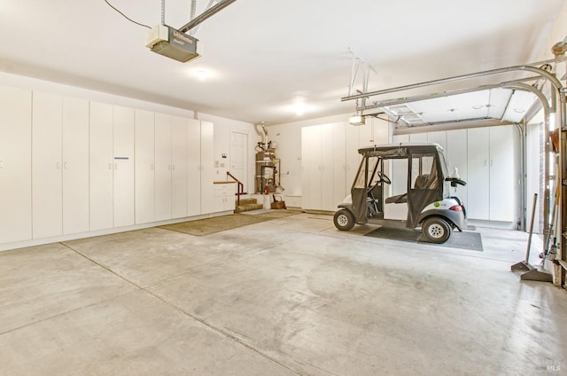 garage with strapped water heater and a garage door opener