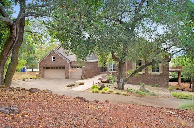 view of property hidden behind natural elements featuring brick siding