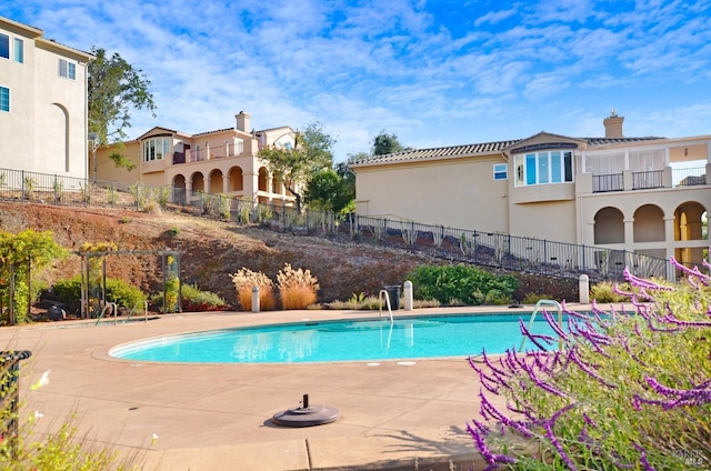 view of pool featuring a patio, fence, and a fenced in pool