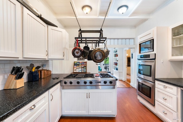 kitchen with wood-type flooring, white cabinetry, and stainless steel appliances