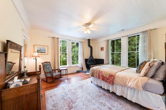 bedroom with hardwood / wood-style floors, wooden ceiling, ceiling fan, and ornamental molding