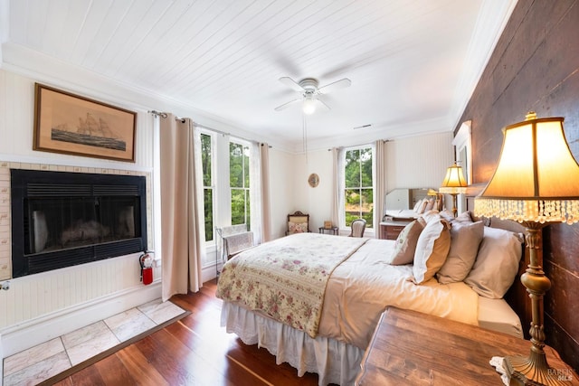 bedroom featuring ornamental molding, wooden ceiling, ceiling fan, and dark wood-type flooring