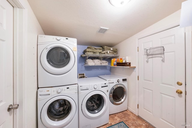 clothes washing area with a textured ceiling and hookup for a washing machine