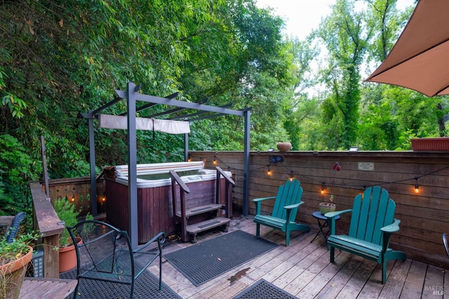 wooden terrace featuring a hot tub