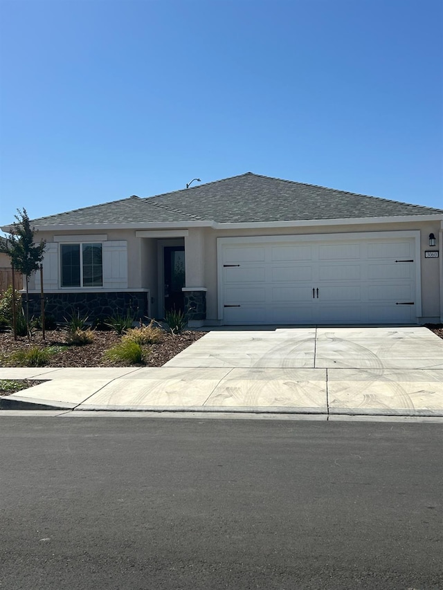 3060 Stones Ln, Stockton, CA 95212 - ranch-style home with concrete driveway, stucco siding, an attached garage, and a shingled roof