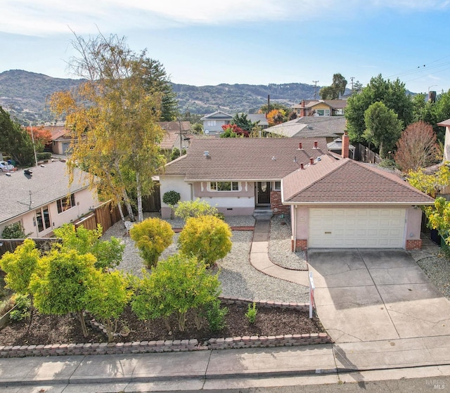 view of front facade featuring a mountain view and a garage