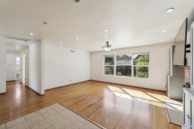 unfurnished living room featuring light wood-type flooring