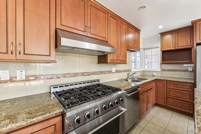 kitchen featuring sink, decorative backsplash, light tile patterned floors, appliances with stainless steel finishes, and light stone counters