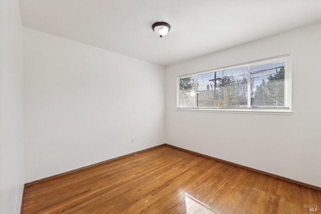 unfurnished room featuring hardwood / wood-style floors