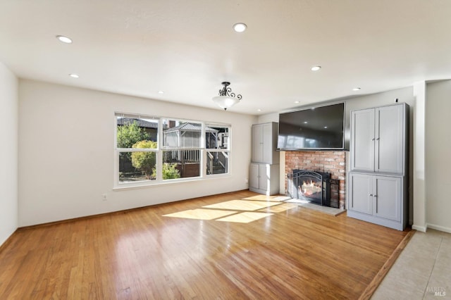 kitchen with decorative backsplash, light stone counters, stainless steel appliances, sink, and a center island