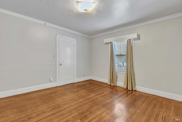 unfurnished room featuring ornamental molding and wood-type flooring