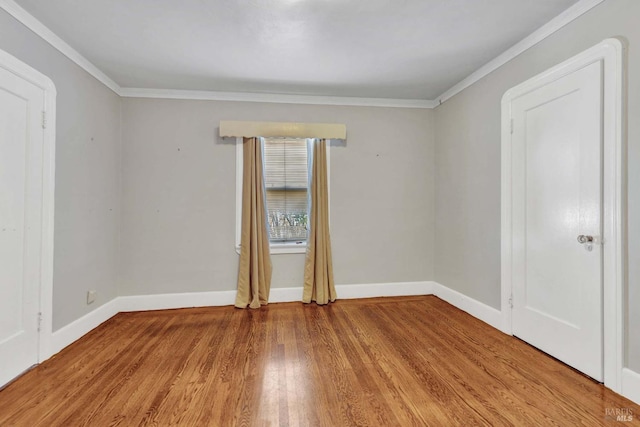 spare room with light hardwood / wood-style flooring and ornamental molding