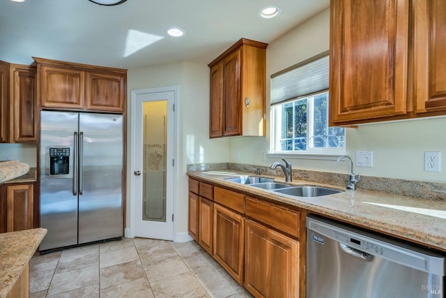19316 N Shore Ct, Hidden Valley Lake, CA 95467 - kitchen featuring a sink, recessed lighting, light stone countertops, brown cabinetry, and appliances with stainless steel finishes