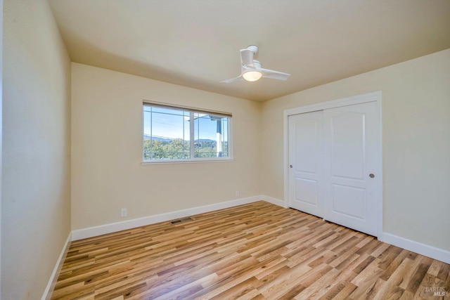 19316 N Shore Ct, Hidden Valley Lake, CA 95467 - unfurnished bedroom featuring visible vents, a closet, baseboards, light wood-style flooring, and ceiling fan