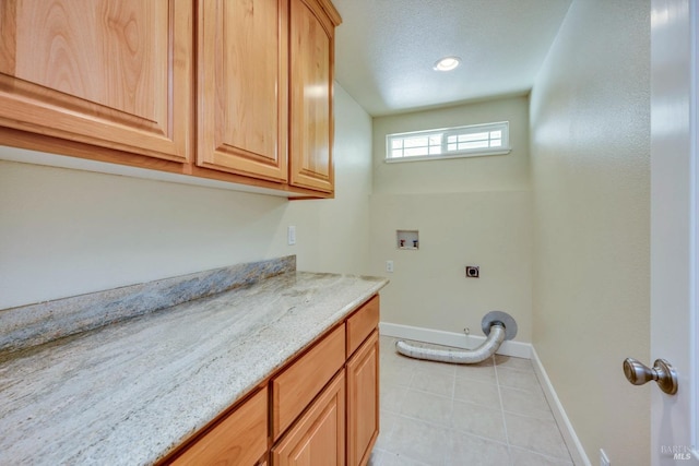 laundry room featuring washer hookup, cabinets, and hookup for an electric dryer