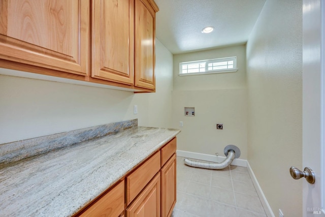 19316 N Shore Ct, Hidden Valley Lake, CA 95467 - laundry room featuring hookup for an electric dryer, light tile patterned flooring, baseboards, washer hookup, and cabinet space
