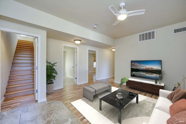 living room featuring light hardwood / wood-style floors and ceiling fan