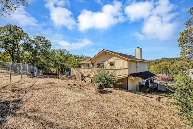 19316 N Shore Ct, Hidden Valley Lake, CA 95467 - view of property exterior featuring a chimney, fence, and a deck