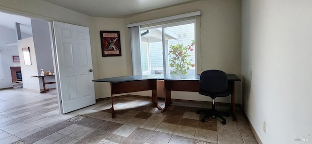 office area featuring a brick fireplace