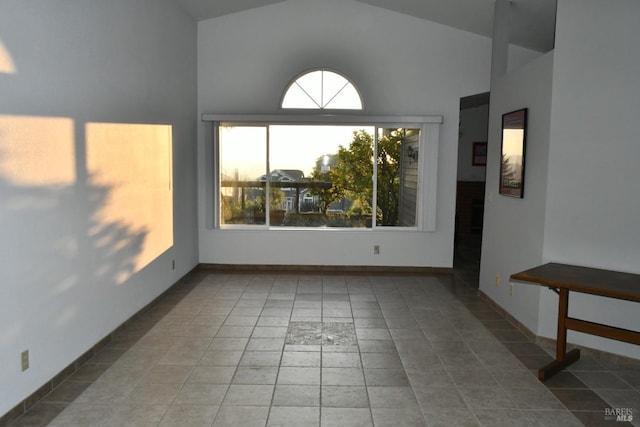 tiled empty room with high vaulted ceiling