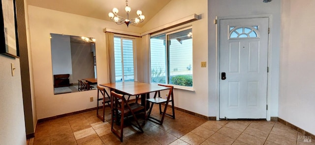 dining space featuring tile patterned flooring, lofted ceiling, a wealth of natural light, and a chandelier