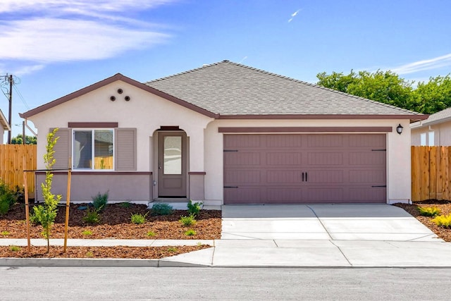 view of front of house with fence, concrete driveway, roof with shingles, stucco siding, and an attached garage