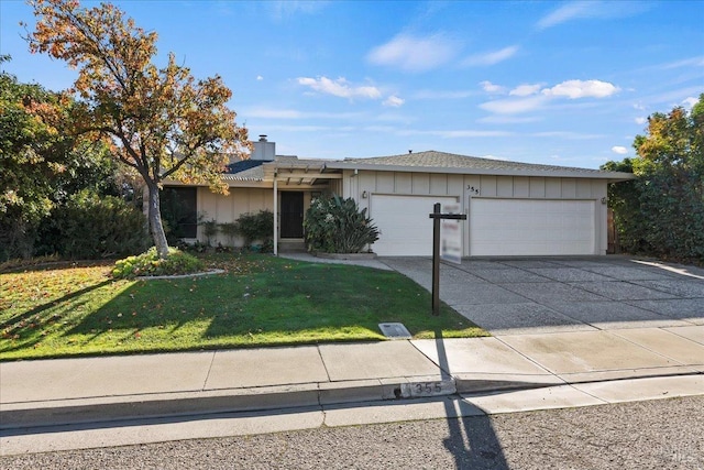 single story home featuring a garage and a front lawn