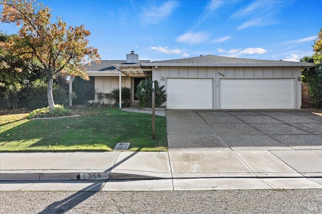 ranch-style home with a front lawn and a garage