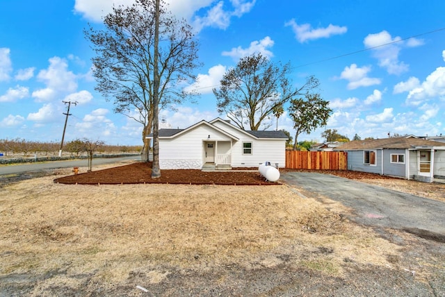 view of front of home featuring fence