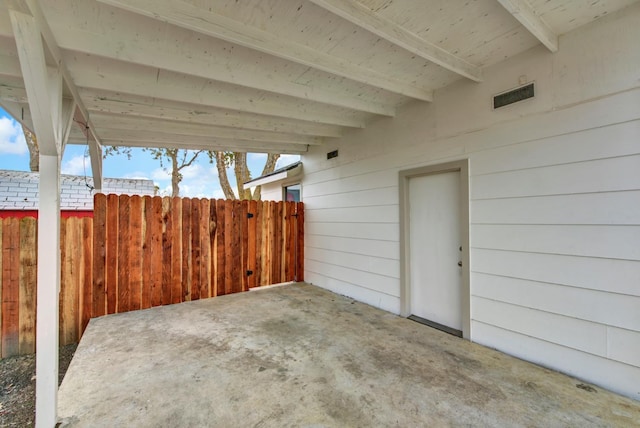 view of patio featuring visible vents and fence