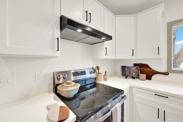 kitchen featuring electric stove, white cabinets, and under cabinet range hood