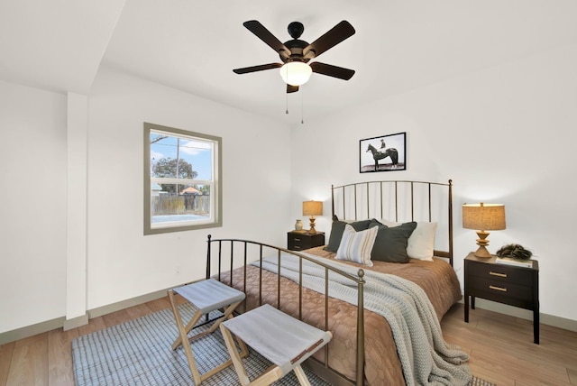 bedroom with ceiling fan and light hardwood / wood-style floors