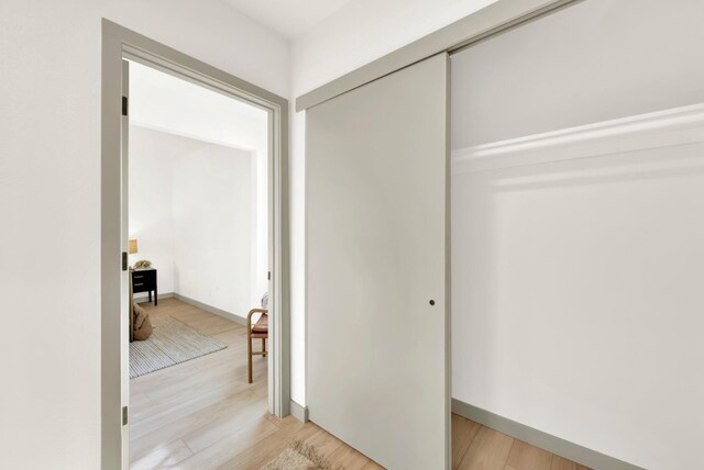 bedroom with ceiling fan, a closet, and light wood-type flooring