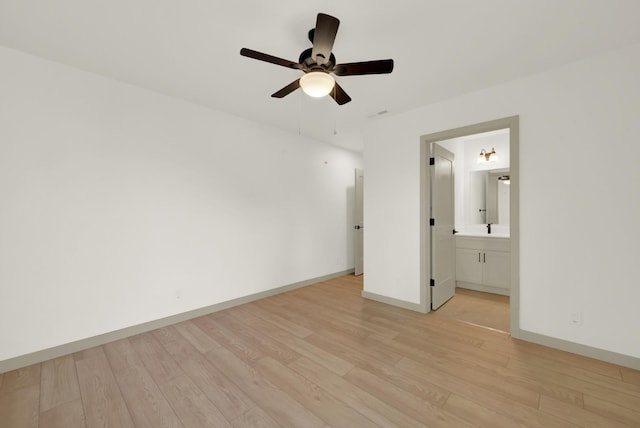 unfurnished bedroom featuring baseboards, ceiling fan, connected bathroom, and light wood-style floors