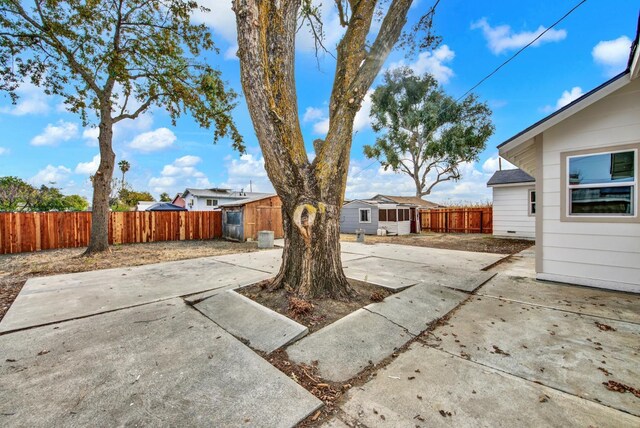 view of patio with a storage unit