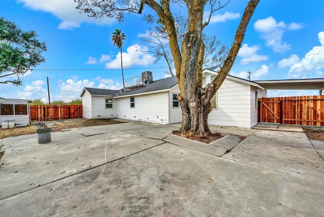 rear view of house featuring fence and a patio