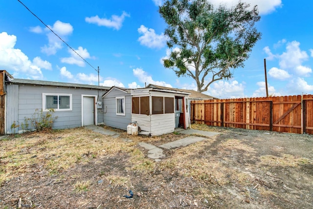 rear view of property with a fenced backyard