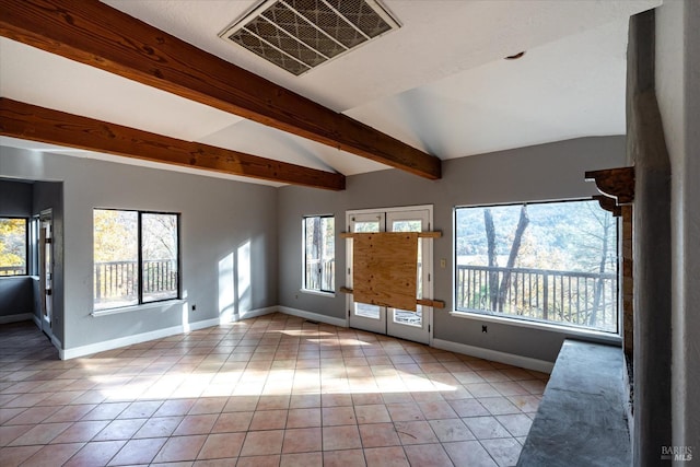 interior space with plenty of natural light, light tile patterned floors, and lofted ceiling with beams