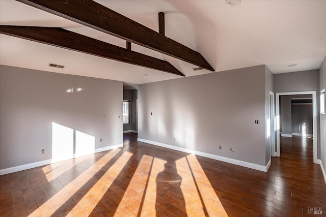 spare room with dark hardwood / wood-style flooring and lofted ceiling with beams