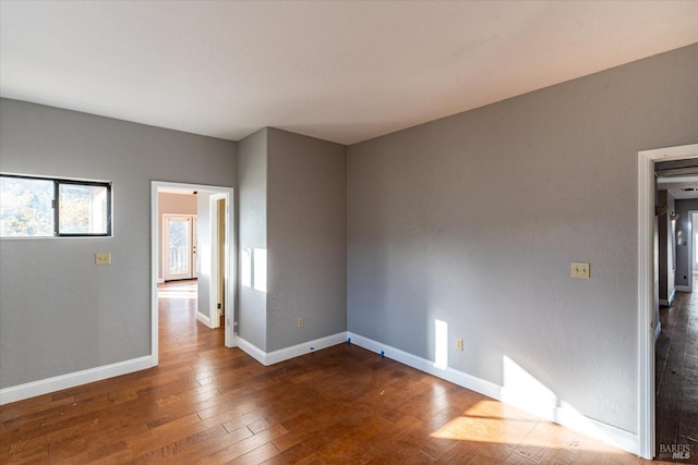 empty room featuring dark hardwood / wood-style flooring