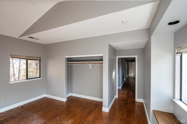 unfurnished bedroom with a closet and dark hardwood / wood-style floors