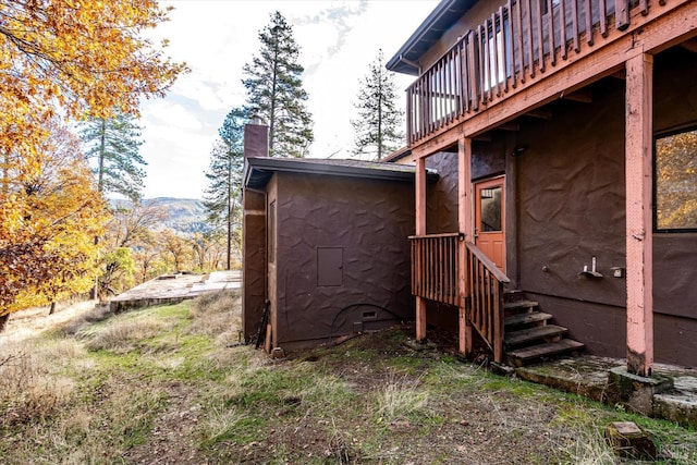 view of home's exterior with a deck with mountain view