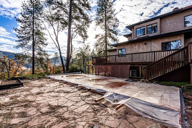 view of patio / terrace with a deck with mountain view