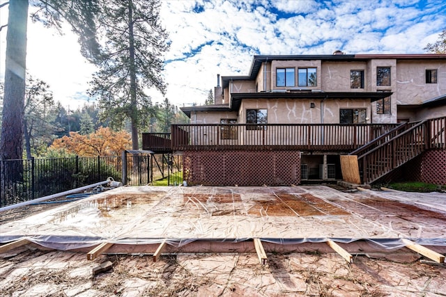 back of property featuring a wooden deck