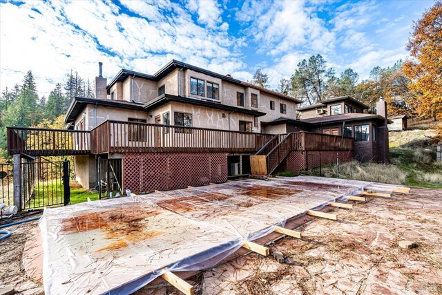 rear view of house with a wooden deck