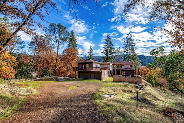 view of front facade featuring a deck with mountain view