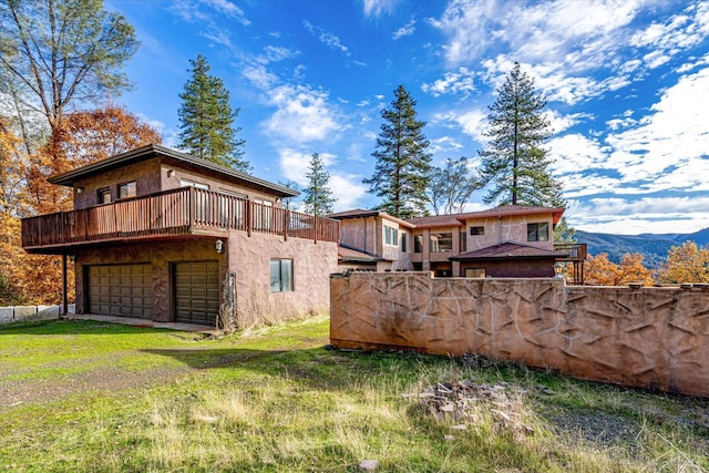 exterior space featuring a deck with mountain view and a garage