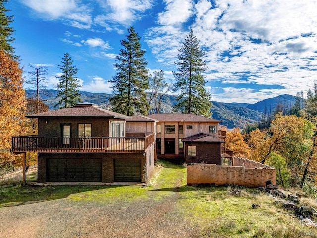 rear view of house with a deck with mountain view