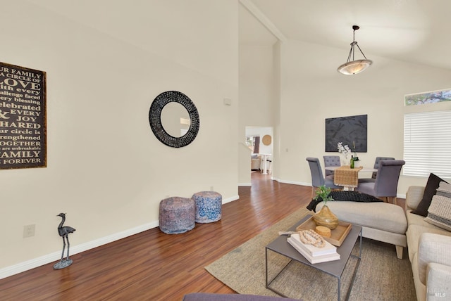 living room featuring hardwood / wood-style flooring and vaulted ceiling