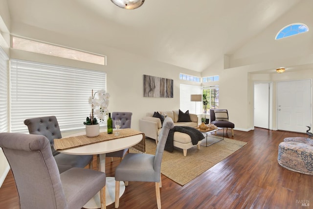 dining space featuring dark hardwood / wood-style floors and high vaulted ceiling